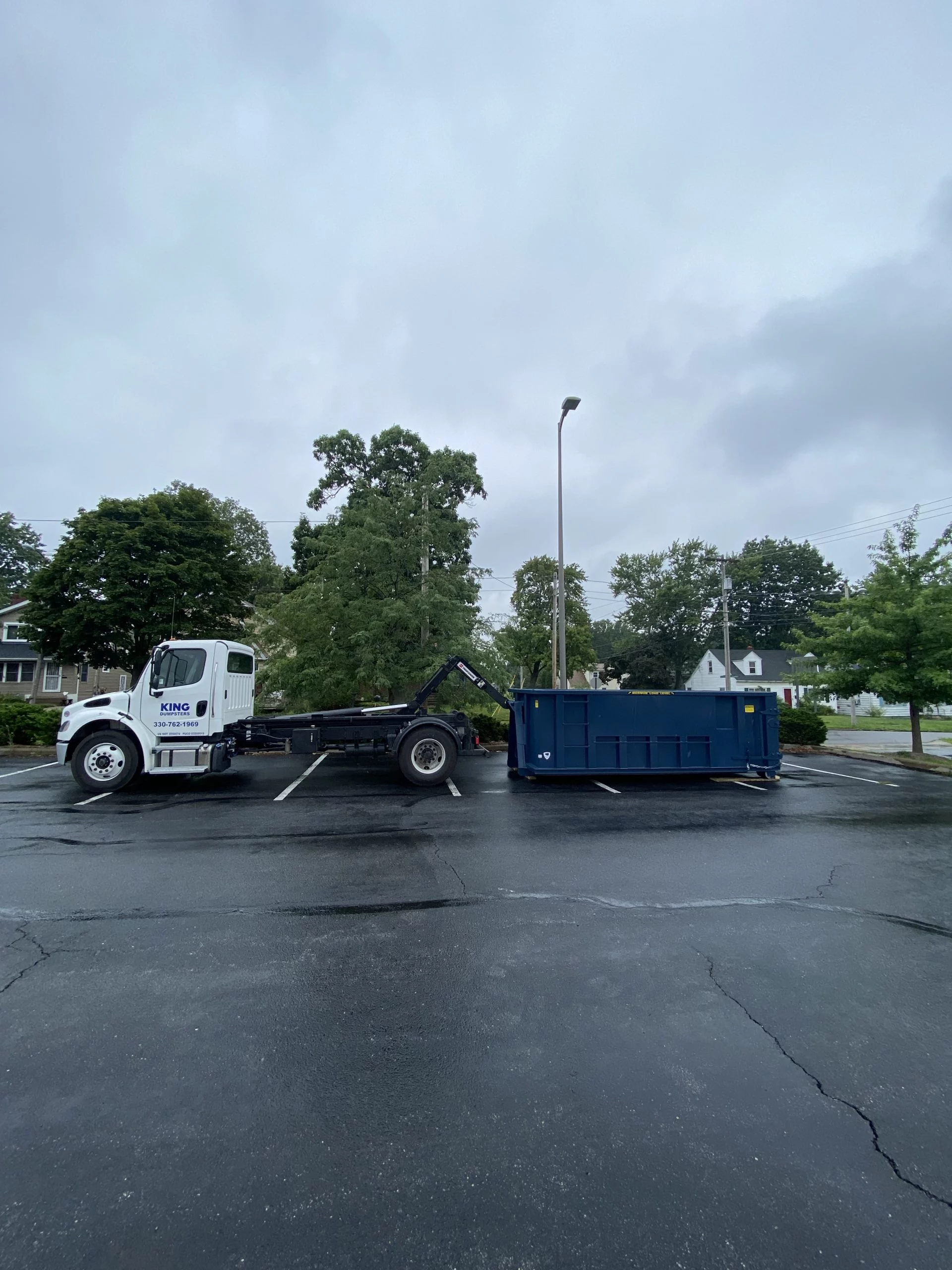 20 yard being delivered to parking lot by King Dumpsters in Akron, Ohio
