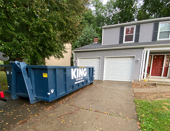 king dumpster rental on driveway